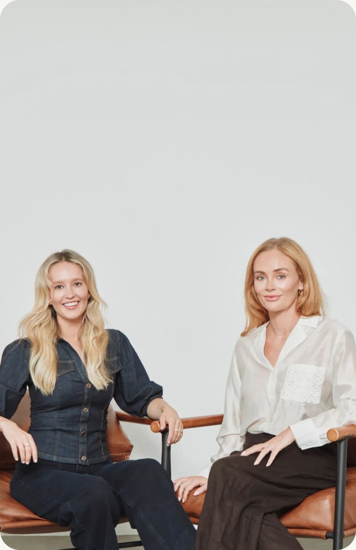 The two founders of WE ARE. REGULAR. seated in leather armchairs
