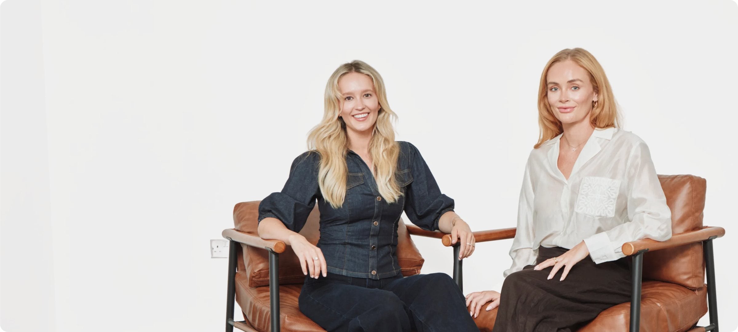 The two founders of WE ARE. REGULAR. seated in leather armchairs